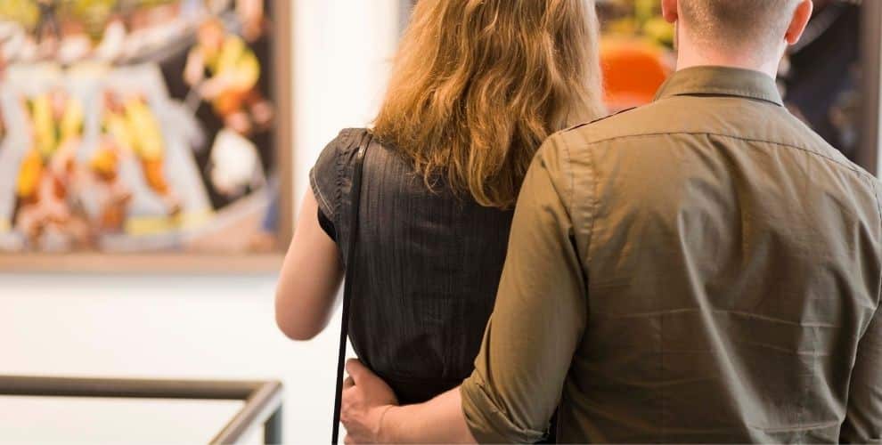 Couple looking at artwork in a gallery